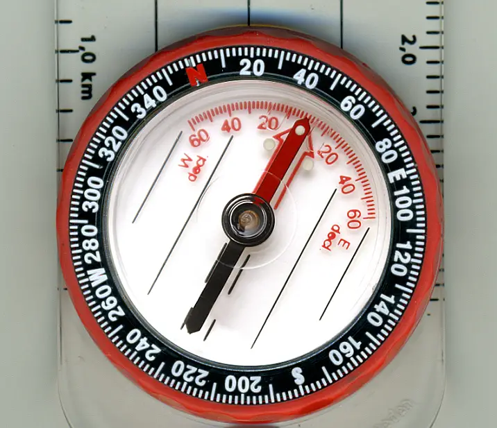 Aligning compass needle with orienting arrow.