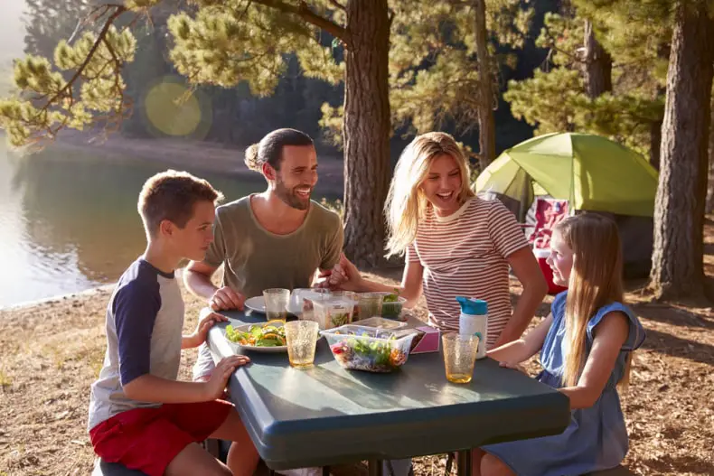 camping family eating a meal