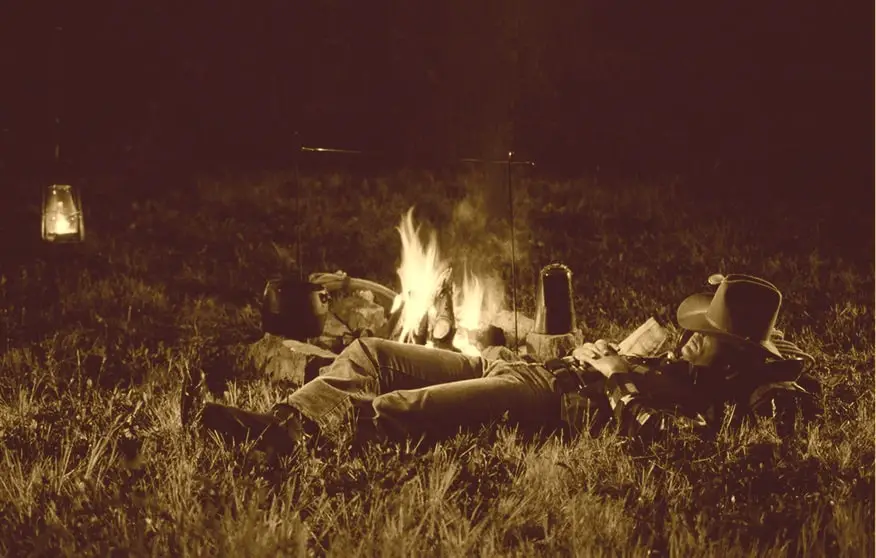 cowboy asleep by the campfire