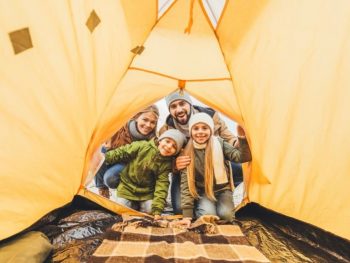 Family looking inside a clean tent.