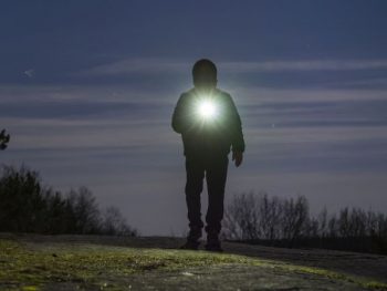 man with flashlight for camping