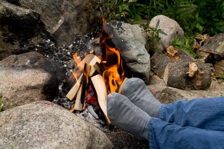 feet by a campfire