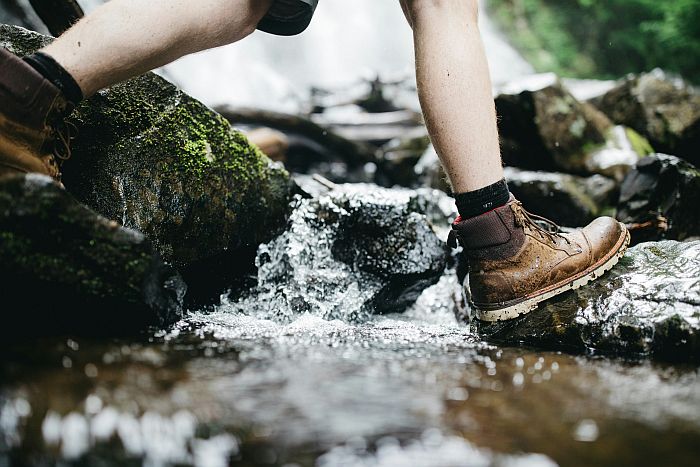 hiking boots crossing a stream