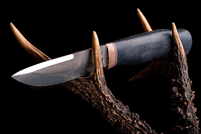 knife sitting on deer antlers