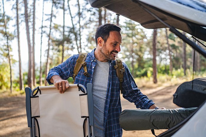 man packing to go camping