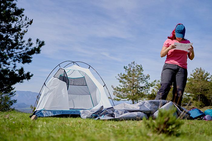 woman setting up a tent