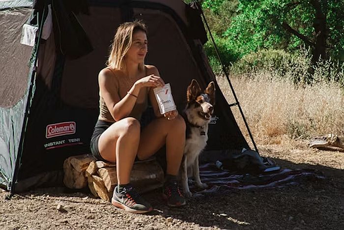 woman sitting in front of a tent